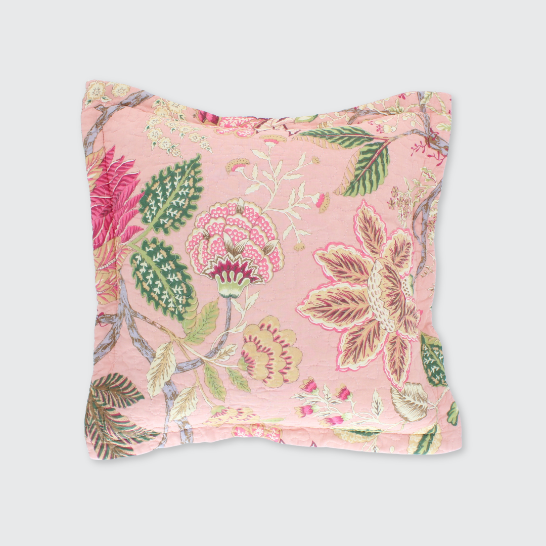 Floral patterned cushion on a soft pink background